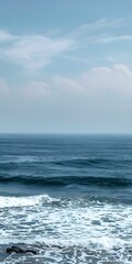 Fototapeta premium Blue Sky and Ocean Waves Crashing on the Shore