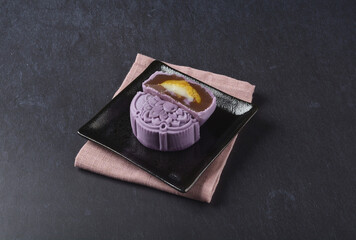premium yam taro purple pink cute healthy baked lotus paste mooncake with layer egg yolk and mochi rose flower 3d shape in black table lantern pastry autumn festival halal asian dessert food menu cafe