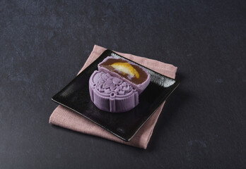 premium yam taro purple pink cute healthy baked lotus paste mooncake with layer egg yolk and mochi rose flower 3d shape in black table lantern pastry autumn festival halal asian dessert food menu cafe