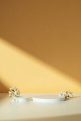 Modern White Geometric Shapes and Flowers on Table Against Orange Wall