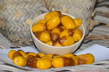 dates fruit in a basket on a wooden table