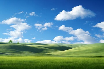 Obraz premium A beautiful summer or spring landscape with green grass on the hills and green fields. The blue sky is filled with white clouds and bright sunlight. Nature as a background.