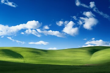 Fototapeta premium A beautiful summer or spring landscape with green grass on the hills and green fields. The blue sky is filled with white clouds and bright sunlight. Nature as a background.