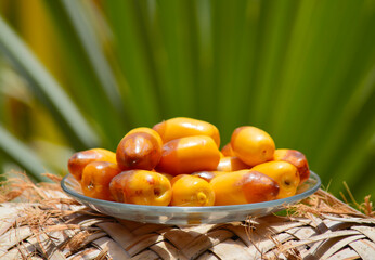 Ramadan food sweet fruit dates in a plate green background