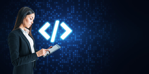 Attractive young european businesswoman using tablet with glowing programming code on blue binary coding background with mock up place. Program and software development concept.