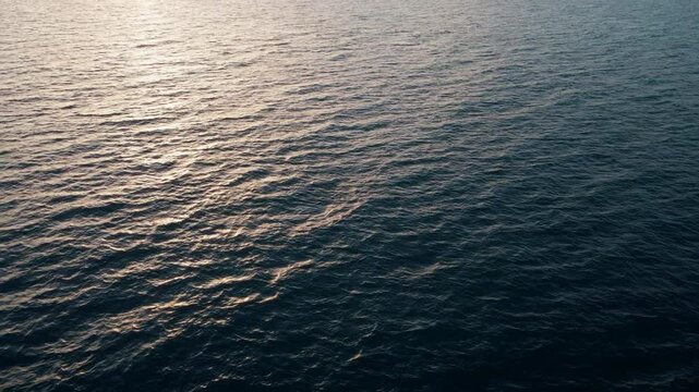 Panning across the sunset sea off the coast of Rome.