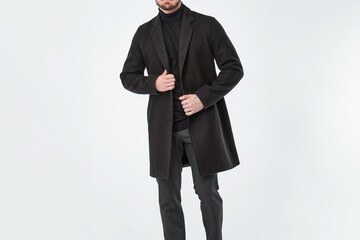 Fashionable man dressed in black overcoat