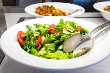 Green Salad with Tomatoes on Plate - Side View