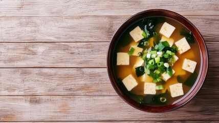 Tofu miso soup with seaweed and green onions, minimalistic Japanese presentation, warm and inviting tones