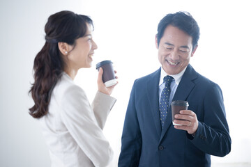 A smiling president or boss who listens to his subordinates over a cup of coffee Image of communication, etc.