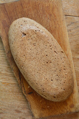Top down view of homemade bread on wooden cutting board