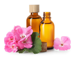 Geranium essential oil in bottles and beautiful flowers isolated on white