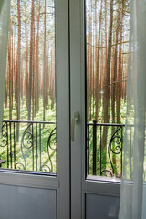 Opened window with summer cityscape