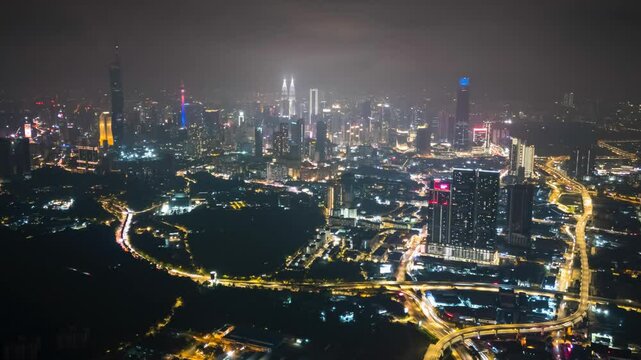 4k aerial time lapse of night scene at Kuala Lumpur city center. Tilt up