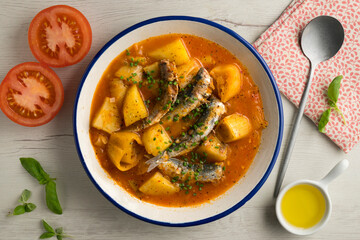 Sardine stew with potatoes and leeks. Top view table with  decorations.