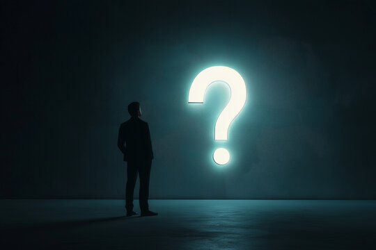 Businessman thinking looking at question mark on wall about the business he is working on.