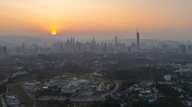 Aerial time lapse of sunrise scene at Kuala Lumpur city skyline. Zoom in