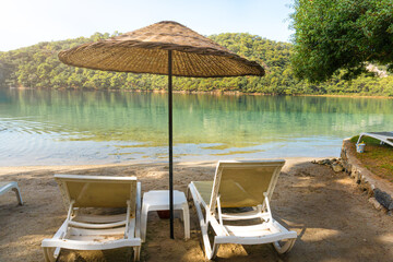 View of Blue Lagoon with Sun Loungers and Umbrellas at a Tropical Resort in Oludeniz, Turkey