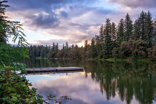 Beautiful reflection of dramatic sunset sky in The Lacamas Lake in Camas, Washington