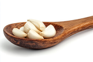 A wooden spoon with garlic on a white background, studio shot, close-up and high-angle view.

