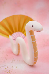 ピンク柄の背景に蛇の立体人形　巳年　年賀素材　