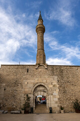 Exterior view of Hizirbey mosque and minaret under blue sky in Egirdir.