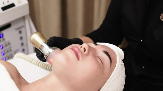 Close-up of a woman receiving an ultrasound cavitation facelift. The image captures the advanced anti-aging treatment, emphasizing the use of ultrasound technology for effective facial rejuvenation.