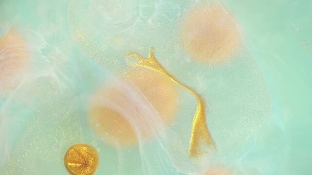 Bright swirls with shiny glittering golden bubbles creating a lively and organic abstract pattern. Color liquid paints moving and mixing. Chaotic motion, bubble flow expansion, curlicue of paints.