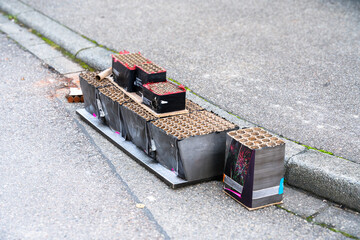Various remains of a New Year's Eve celebration on the sidewalk of a street