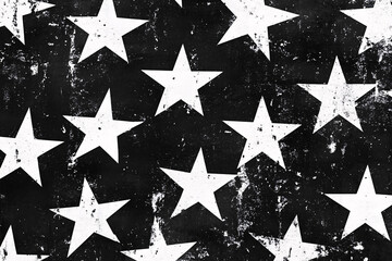 black and white pattern of distressed stars arranged in rows creating a bold and grungy abstract design