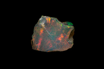 Beautiful natural rough precious Opal gemstone show the opalescence phenomenon on dark background