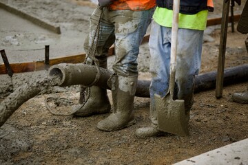 workers pouring concrete on a construction site