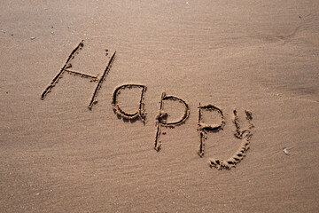 inscription on the sand of Happy