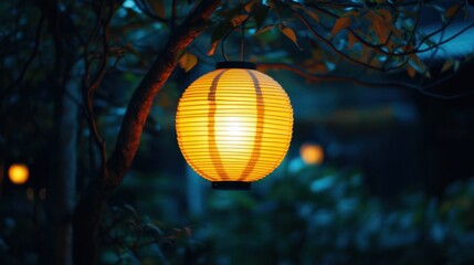 Obraz premium A warm yellow lantern hanging from a tree branch, softly lighting a garden at night.