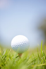 Grass, tee ball and golf course at country club in nature for fitness, competition or game. Mockup space, tournament and closeup of sport for practice on field with position set for outdoor hobby.
