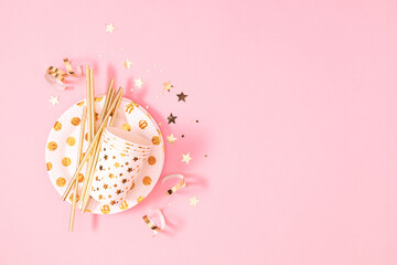 Christmas composition. Christmas golden decorations on pastel pink background. Flat lay, top view, copy space