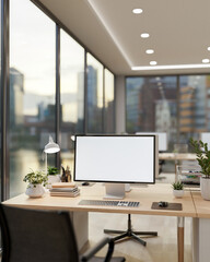 A computer desk by the window with a stunning view of city skyscrapers.