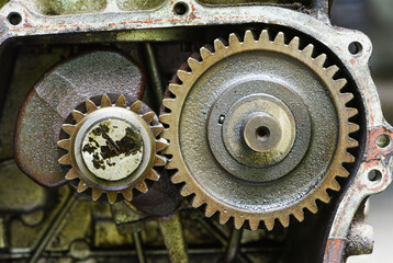 small four stroke engine gears with oil traces and dirt . close up view of engine gear wheels .