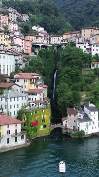 Aerial view of Civera Bridge over Como Lake with picturesque homes and lush greenery, Nesso, Italy.