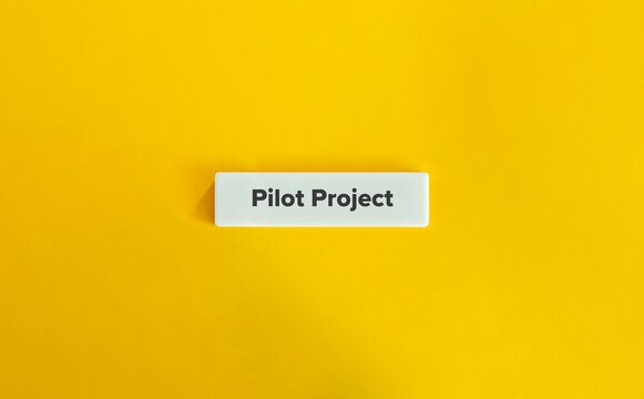 Pilot Project Banner. Text on Block Letter Tile on Yellow Background. Minimal Aesthetic.