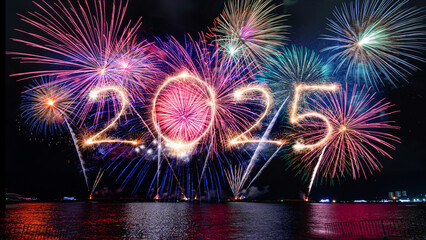 Sparkler 2025 text colorful firework illumination on dark blue sky background, happy new year 2025...