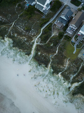 Aerial view of beautiful beach and dunes with people and houses, Atlantic Beach, United States.