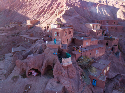Aerial view of a picturesque village with traditional adobe houses nestled in a remote mountainous landscape, Bamyan, Afghanistan.