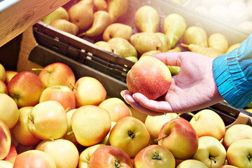 Apple in hand in market