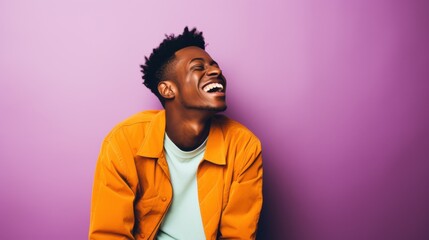 Fototapeta premium A young man stands against a brightly colored background, embodying vibrancy and youthful energy with his thoughtful expression and trendy white hoodie.