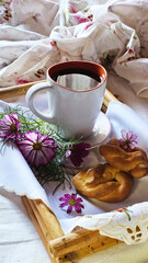 Coffee and cakes on a tray on the bed