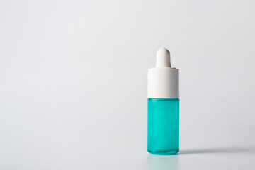 Blue glass cosmetic bottle, Skin care or sunscreen cosmetic  on white background.