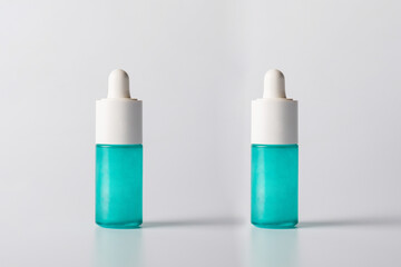 Blue glass cosmetic bottle, Skin care or sunscreen cosmetic  on white background.