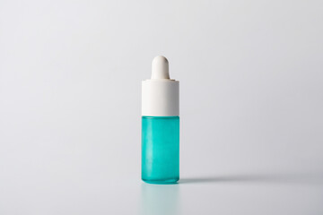 Blue glass cosmetic bottle, Skin care or sunscreen cosmetic  on white background.