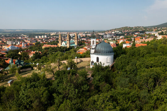 Aerial view of the picturesque cityscape with historic churches and lush greenery, Pecs, Hungary.